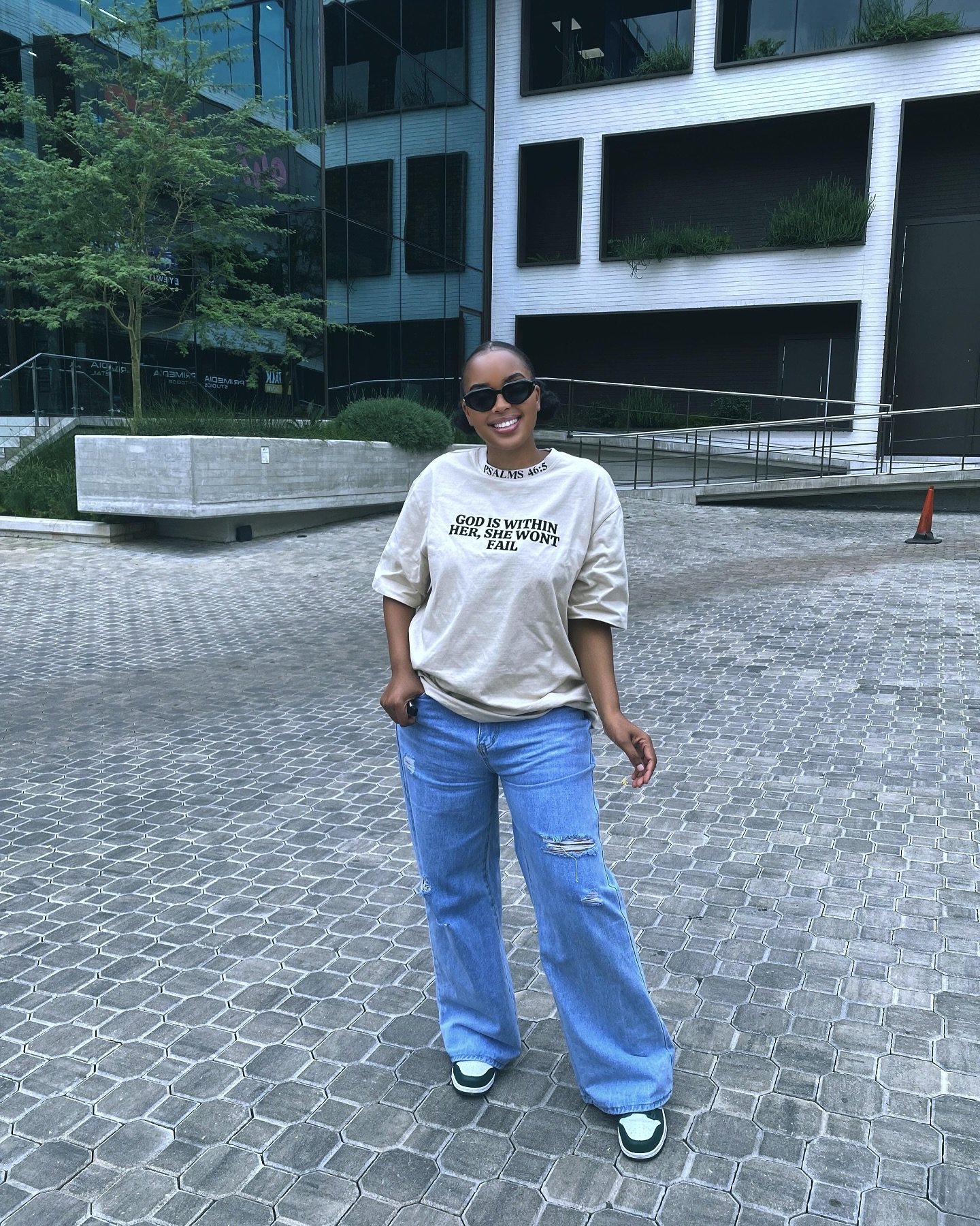 Woman in city wearing faith tee