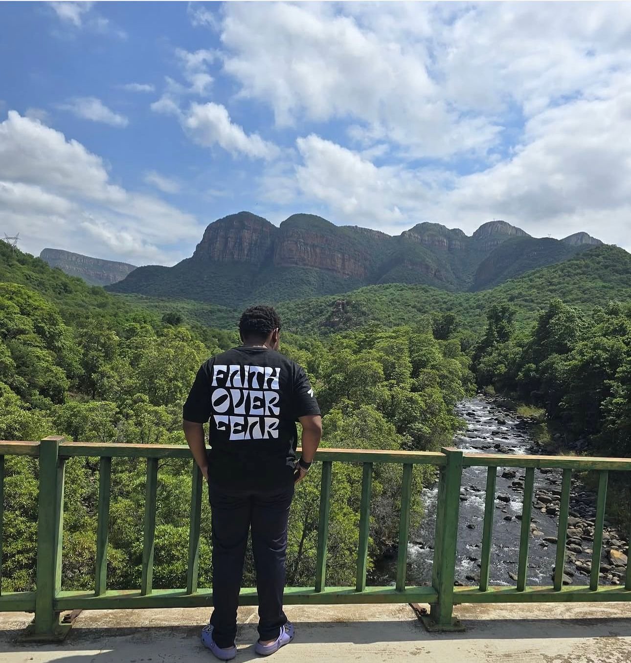 Man wearing Faith Over Fear tee overlooking the Blyde River Canyon