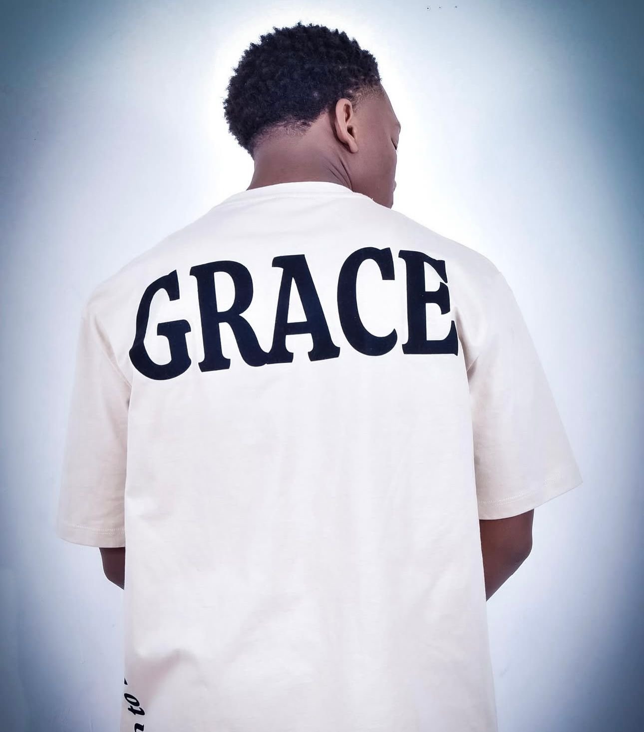 Model wearing a cream GRACE tee — one word, a whole identity